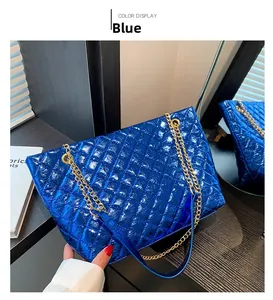 Detail of metallic blue quilted shoulder bag with diamond stitching and gold chain strap