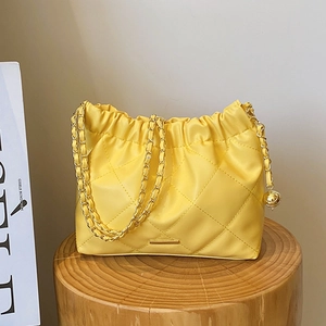 Yellow soft leather quilted chain shoulder bag with drawstring and golden ball charm