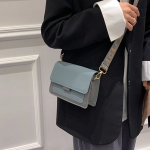 Morandi blue crossbody bag with wide jacquard shoulder strap in a minimalist style