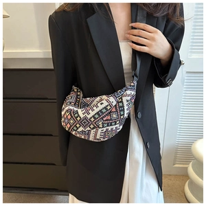 Ethnic woven crescent bag with geometric patterns and black adjustable shoulder strap