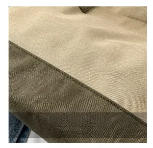Dettaglio ravvicinato del materiale in tela spessa con cuciture a contrasto verde e beige