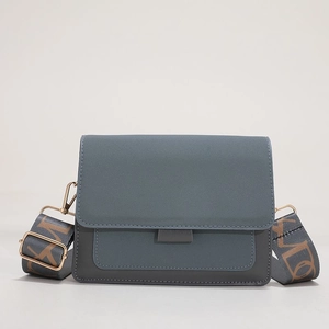 Minimalist matte crossbody bag with grey-blue flap and stylish wide fabric shoulder strap