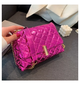 Detail of metallic pink quilted shoulder bag featuring gold chain and turn-lock closure