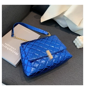 Detail of blue metallic quilted crossbody bag with gold twist lock and chain strap