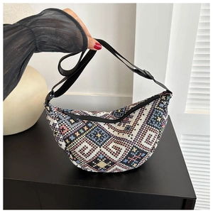 Detailed close-up of a bohemian woven crossbody bag with colorful geometric patterns