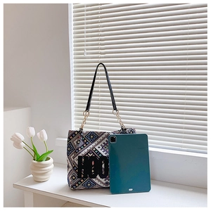 Detailed view of spacious ethnic patterned tote bag showing capacity with a tablet