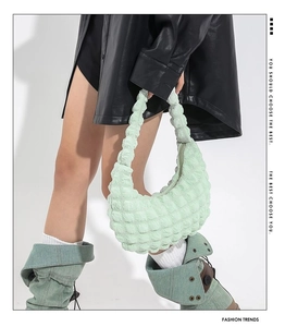 Detail of mint green ruffled cloud bag featuring high-quality waffle texture fabric