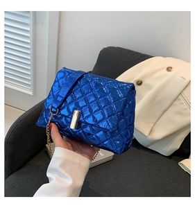 Close-up of electric blue metallic quilted shoulder bag with gold chain strap