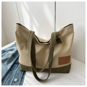 Dettaglio di una grande borsa tote in tela bicolore kaki e verde oliva con manici