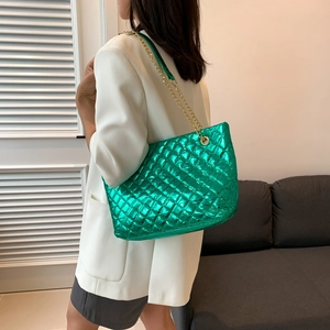 Metallic green quilted chain tote bag with high-capacity design shown on female model