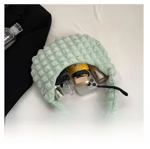 Interior view of light green bubble texture handbag showing capacity for phone and umbrella
