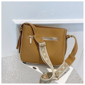 Detail of tan faux leather crossbody bag with ethnic jacquard wide shoulder strap