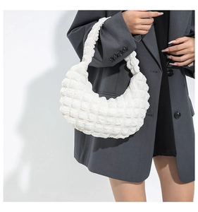 Detail of white cloud bubble bag featuring pleated texture and crescent moon shape design