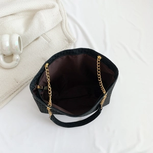 Large black texture tote bag with gold chain strap and spacious interior for commuting