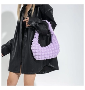 Detail of lavender cloud pleated bubble texture handbag on model with leather jacket
