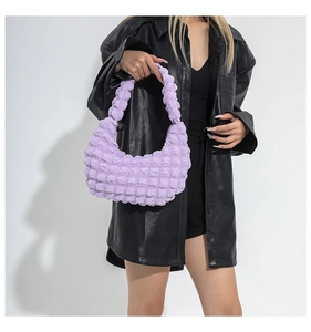 Detailed view of light purple popcorn fabric texture on a pleated shoulder bag for women