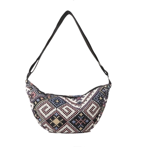 Bohemian style woven crescent crossbody bag with colorful geometric patterns and black strap