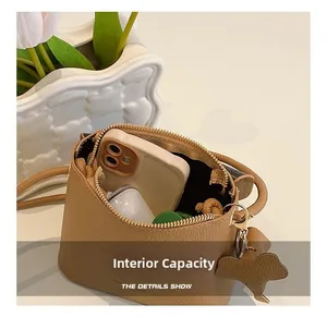 Internal capacity of khaki leather bucket bag showing storage for a smartphone