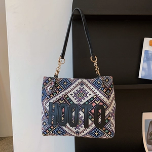 Ethnic style woven tote bag with geometric patterns and leather chain strap