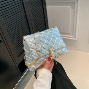 Quilted silver crossbody bag with golden chain strap and cylindrical metal lock