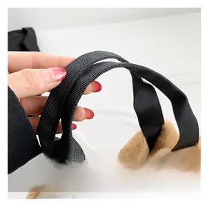 Detailed macro view of soft brown plush faux fur fabric with a durable black nylon strap