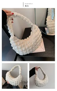 Detail of off-white cloud pleat bubble bag with textured fabric and metal zipper