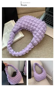 Detail of purple cloud bubble texture hobo bag with integrated handle in daily setting