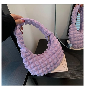Detail of lavender pleated cloud bag with bubble texture and golden metal zipper