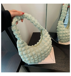 Detailed bubble texture and zipper closure on a mint green minimalist hobo bag