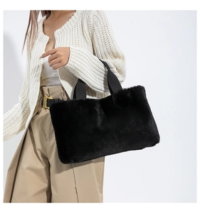 Detail of soft black faux fur tote bag with reinforced canvas handle for winter fashion