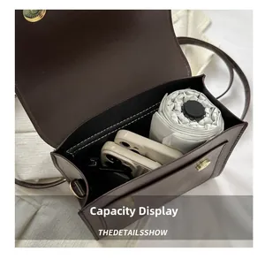 Macro view of dark brown leather handbag interior showcasing daily storage capacity