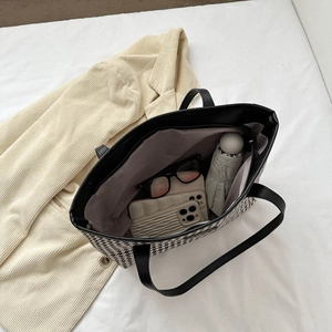 Large houndstooth tote bag showing spacious interior with phone, sunglasses and umbrella