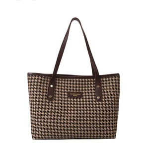 Classic brown houndstooth tote bag with dark leather handles and gold metal rivets