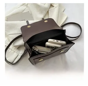 Detail view showing interior capacity of brown leather bucket bag with two magnetic snaps
