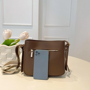 Coffee brown minimalist crossbody bag with wide strap and front zipper compartment