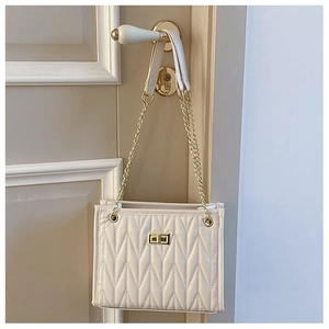 Detailed view of cream quilted PU leather shoulder bag with gold square twist lock clasp