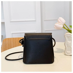 Detail of black pebbled leather texture on a minimalist small crossbody bag for women