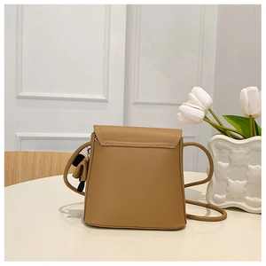 Close-up of minimalist camel crossbody bag showing high-quality pebble grain leather texture