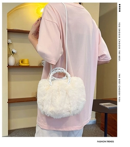 Close-up of white faux fur handbag featuring woven handles and soft cloud-like texture