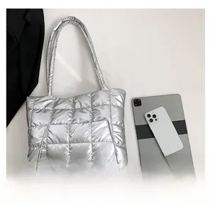 Détail d'un grand sac cabas argenté matelassé avec poche extérieure et vue de dessus