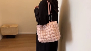 Pink quilted tote bag detail with leather chain strap and lightweight nylon texture