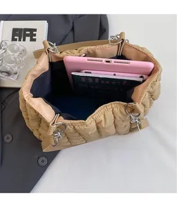 Detail view of khaki quilted tote bag showing large interior capacity for daily essentials