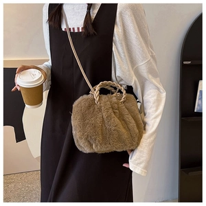 Brown faux fur plush handbag with woven handle and strap shown in a casual lifestyle setting