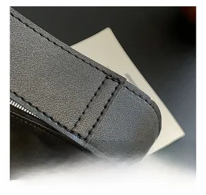 Macro view of lychee pattern leather texture with high density stitching on black shoulder bag