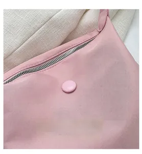 Detail of pink waterproof nylon bag showing high-quality zipper and metal buckle