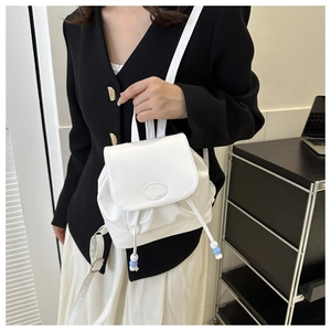 Détail d'un mini sac à dos blanc avec cordon de serrage et logo Fashion rabat