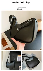 Detail view of black hobo shoulder bag with embossed fashion text and adjustable strap