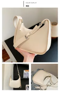 Detail view of off-white faux leather hobo bag showing adjustable strap and fashion lettering