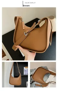 Detail of adjustable silver buckle and smooth brown PU leather on crescent bag