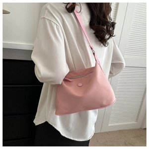 Pink nylon water-resistant shoulder bag with adjustable strap and silver zipper closure
